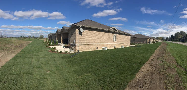 Wide angle shot of sod lawn work done for new build houses.