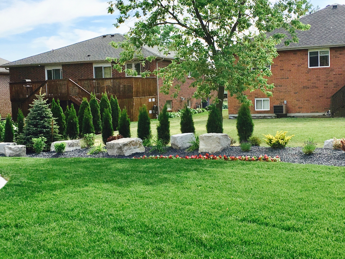Stone, mulch, and shrubbery residential work.